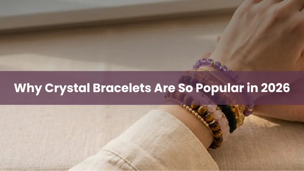 Hand wearing multiple healing crystal bracelets showing why crystal bracelets are popular in 2026